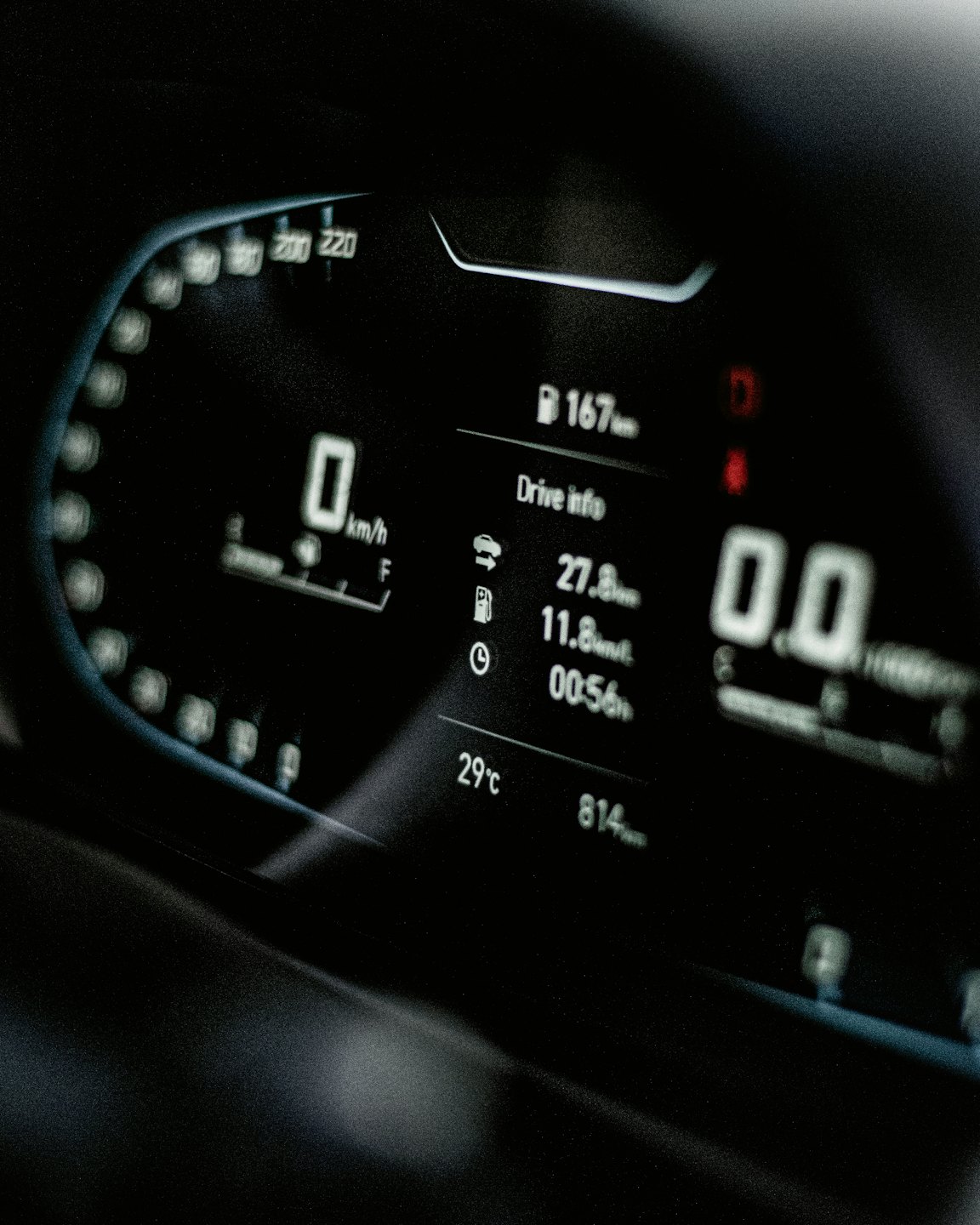 Modern car dashboard display showing speed and fuel metrics.